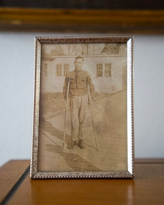 antique portrait of man on crutches